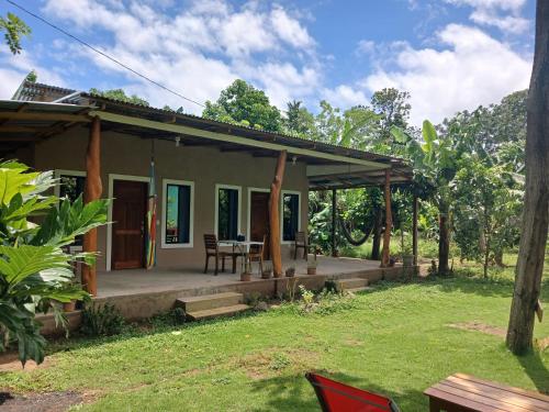 a small house with a porch and a table at Sunny Garden Lodge in Mérida