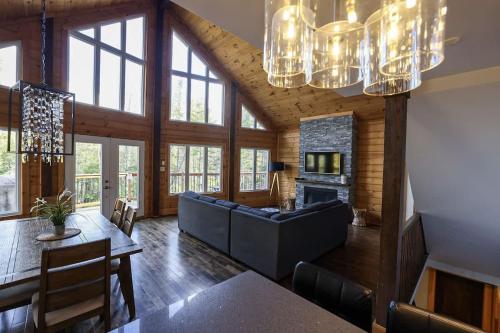a living room with a couch and a fireplace at Chinook 172 in Sainte-Marguerite