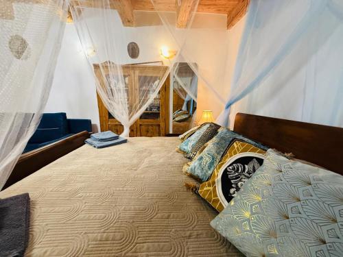 a bedroom with a large bed with curtains on it at Zázrak Wellness in Banská Štiavnica