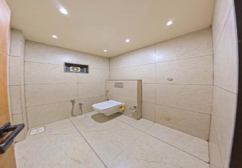 a bathroom with a toilet and a shower at V Club in Bhuj