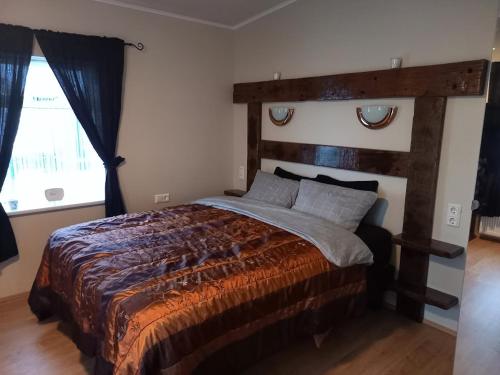 a bedroom with a large bed and a window at Rólegt in Ísafjörður