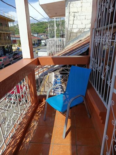 a blue chair sitting on a balcony at Hostal Expansion in San Juan del Sur