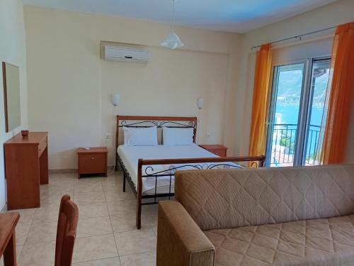 a bedroom with a bed and a couch at Armonia Nakas in Yénion