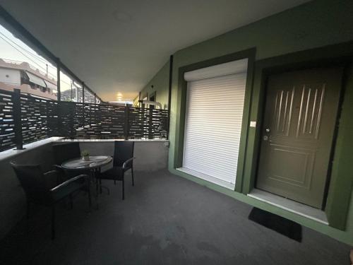 a room with a table and chairs and a window at Elia Apartments in Eretria