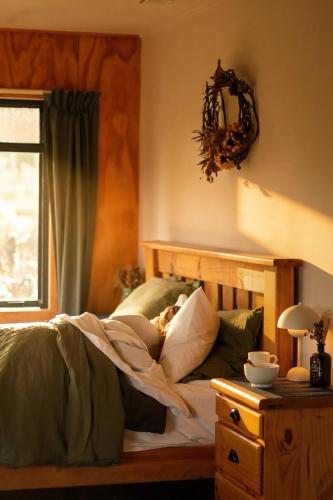 a bedroom with a bed and a window at Fiery Peak Eco-Retreat with Stargazing & Hot tub in Geraldine