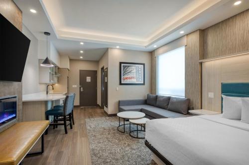 a hotel room with a bed and a kitchen at Best Western PLUS City Centre Inn in Edmonton