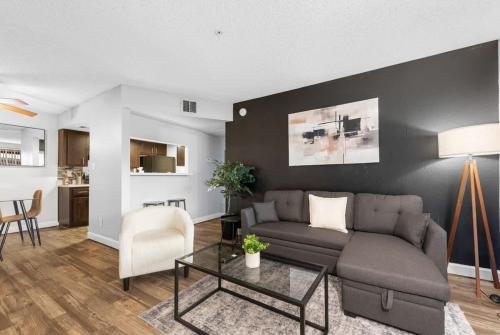 a living room with a couch and a table at Tempe Hideaway Luxe Amenities Parking in Tempe