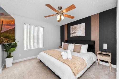 a bedroom with a bed with a ceiling fan at Tempe Hideaway Luxe Amenities Parking in Tempe