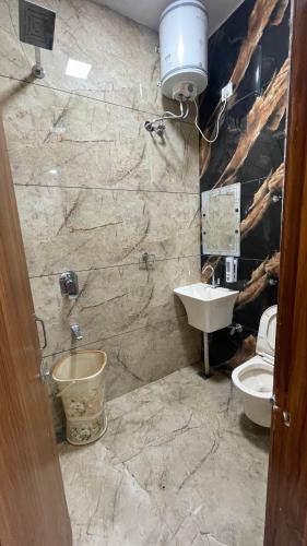 a bathroom with a sink and a toilet at Hotel 48 in Amritsar