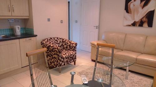 a living room with a couch and a chair at St Bridget's Apartments in Galway