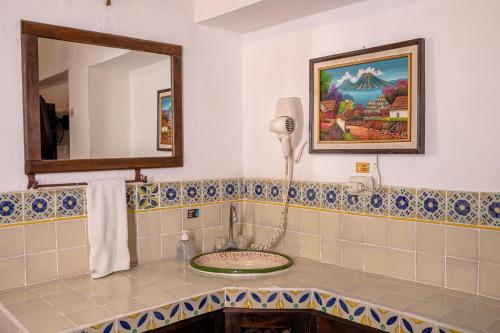 a bathroom with a sink and a mirror at Hotel Casa Antigua by AHS in Antigua Guatemala