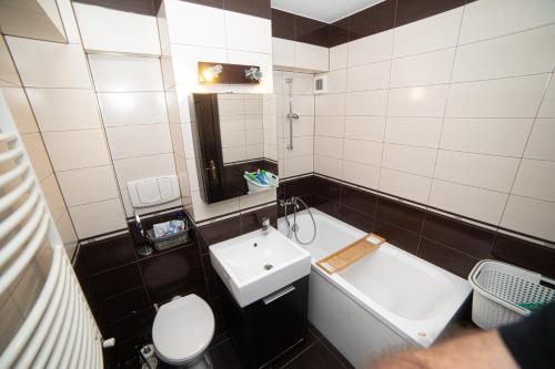 a small bathroom with a sink and a toilet at M-Buf Center Apartament in Gura Humorului