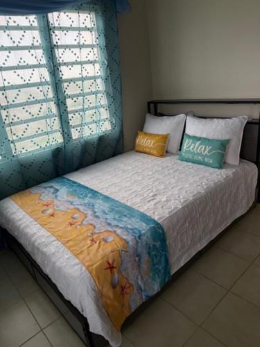 a bed with two pillows on it in a bedroom at Peaceful Studio Retreat Near Shoal Bay Beach in Shoal Bay Village