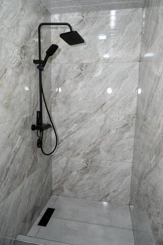 a shower with a shower head in a bathroom at EKA Resort in Goris