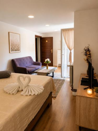 a hotel room with a bed and a couch at Nature Bliss Villa in Sarajevo