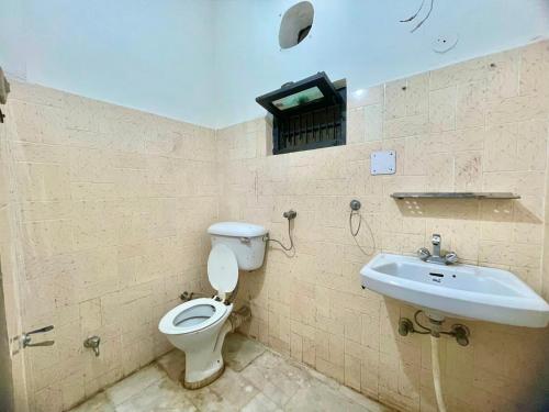 a bathroom with a toilet and a sink at Land Chaster Kasauli in Kasauli