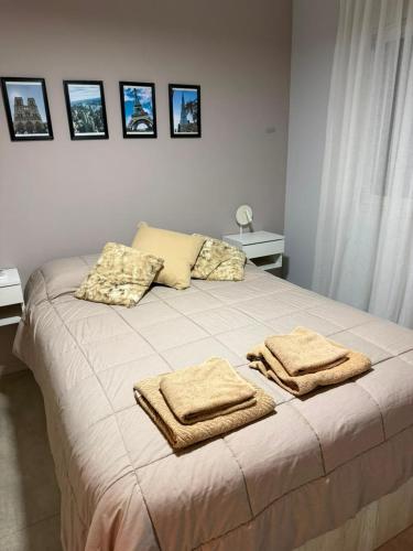 a bedroom with a bed with towels on it at Departamento Rivadavia in Santa Fe