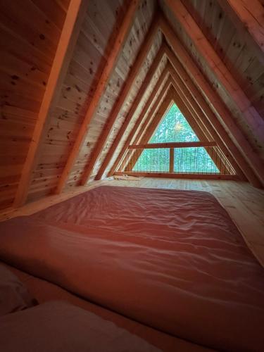 a bed in a room with a window at Mountain heaven in Andrijevica