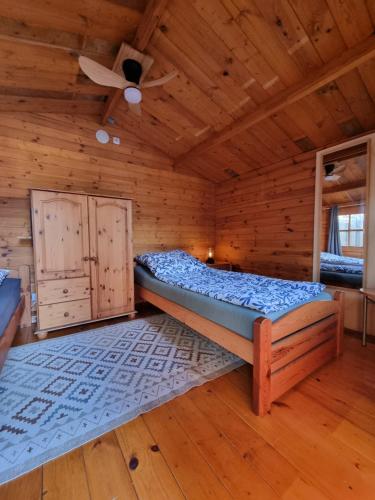 a bedroom with a bed in a wooden cabin at Sommerhaus in Eggstedt