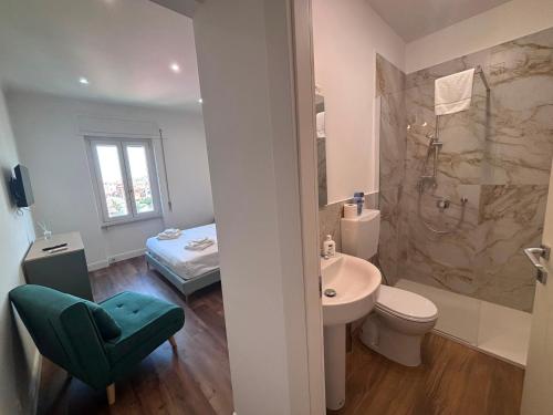 a bathroom with a sink and a toilet and a shower at Mare di Roma 2 in Lido di Ostia