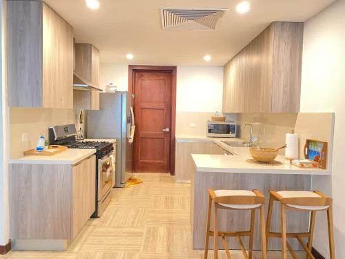 a kitchen with a counter and some chairs in it at Charming two-bedroom apartment in Las Terrenas in Las Terrenas