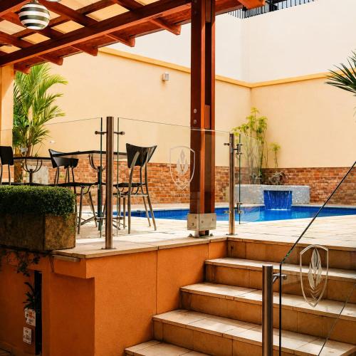 a patio with a table and chairs and a pool at hostal cf bed y breakfast in Cali