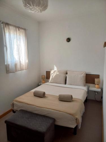 a bedroom with a large bed and a window at Poço Cávado House T3 in Geres