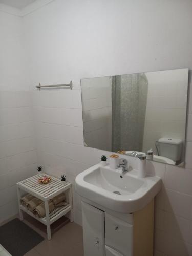 a white bathroom with a sink and a mirror at Poço Cávado House T3 in Geres