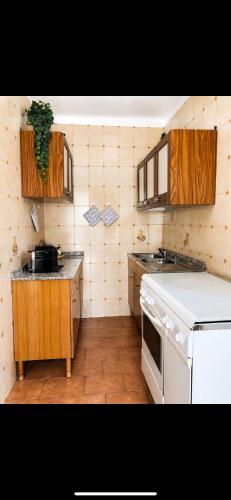 a kitchen with a sink and a stove top oven at Casa Giulia in Pula