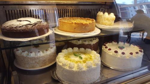 
a display case filled with cakes and pastries at Hotel-Cafe Rathaus in Bad Abbach
