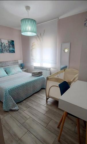 a bedroom with a bed and a couch and a lamp at El Colibrí de Taraza in San Pedro de Latarce