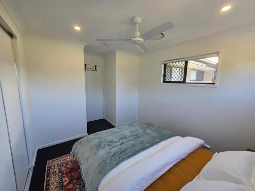 a white room with a bed and a window at Private Room with Queen Bed & Bathroom in Bellbird Park
