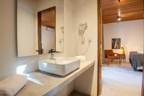 a bathroom with a sink and a mirror at Villaflor Pousada in Vale do Capao