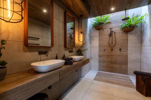 a bathroom with two sinks and a shower at BullerRoo Luxury Chalet & Cottage Farmstay in Barwite