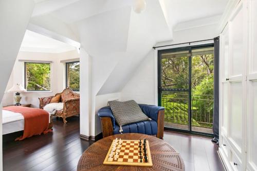 a room with a chessboard on a table and a bed at Gorge Castle in forest landscape in Galston