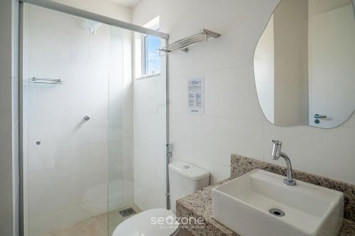 a bathroom with a shower and a sink and a toilet at Studio in Condo with Pool and Gym MSU0906 in Governador Valadares