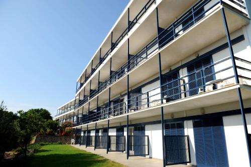 an apartment building with balconies on the side of it at Delfinia Hotel & Bungalows in Mithymna