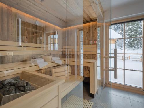 a room with wood paneling and a glass wall at Donnersbach Lodge in Donnersbachwald