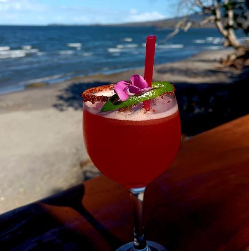 a drink sitting on a table next to the ocean at exotic island ometepe in Altagracia