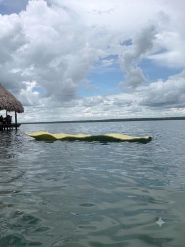 a yellow boat in the water near a beach at Taitza in San José