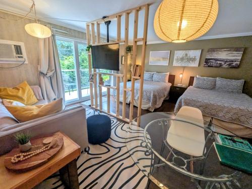 a living room with a bed and a couch and a table at Evergreen Bed & Breakfast in Hope