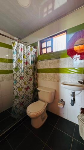 a small bathroom with a toilet and a sink at Glamping Store in Guatavita