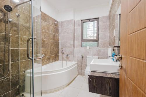 a bathroom with a tub and a toilet and a sink at Rolling in Nairobi