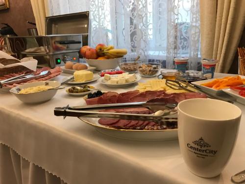 a table with a buffet of food on it at CenterCity Apartments in Prešov