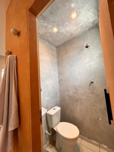 a small bathroom with a toilet and a shower at Loft Moderno I in Mossoró