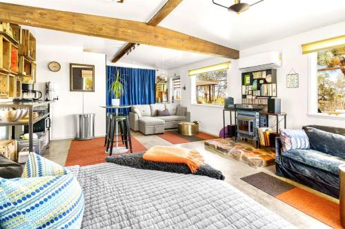 a living room with a couch and a fireplace at Cowboy Tubs, Zen Labyinth, Views, Quiet Serenity in Joshua Tree