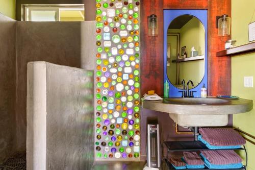 a bathroom with a sink and a mirror at Cowboy Tubs, Zen Labyinth, Views, Quiet Serenity in Joshua Tree