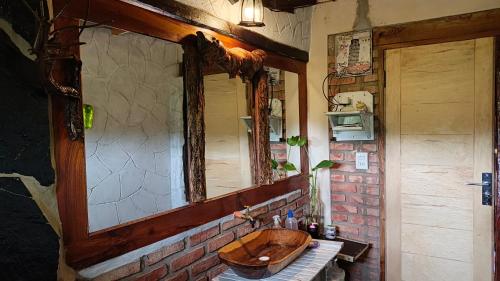 a bathroom with a wooden sink and a mirror at Cabaña Renacer in Samaipata