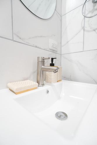 a bathroom sink with a faucet and a mirror at La Palma Experience in Panama City