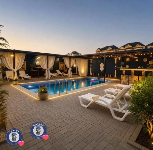 a resort with a swimming pool and lounge chairs at Caspian Seaside Hotel in Sumqayıt